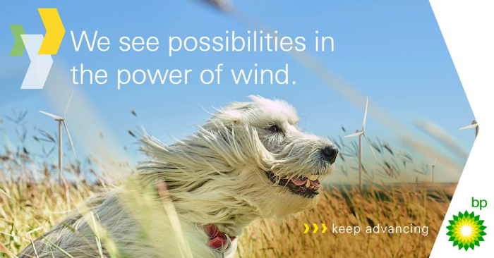 A happy-looking dog sits in a field of wheat, its fur blown by the wind, against the backdrop of a blue sky. The caption reads "We see possibilities in the power of wind.' Adjacent to the green BP logo, the tagline reads 'keep advancing".
