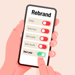 A digital illustration of a hand holding a smartphone displaying a toggle menu labelled "Rebrand." The menu shows options for timing a rebrand: "Today," "Tomorrow," "Next week," "Next month," and "Next year," with the "Next year" option switched on. The image conveys the idea of delaying action or postponing decisions related to branding.